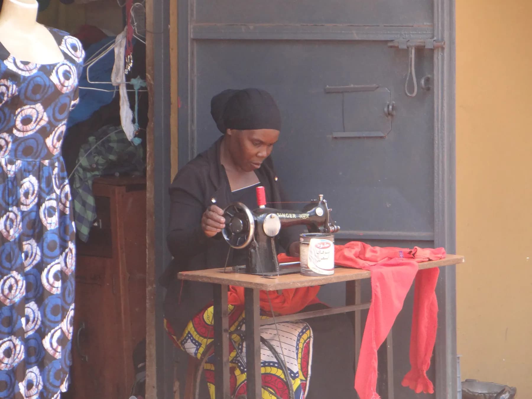 A seamstress at her sewing machine in a neighbourhood workshop